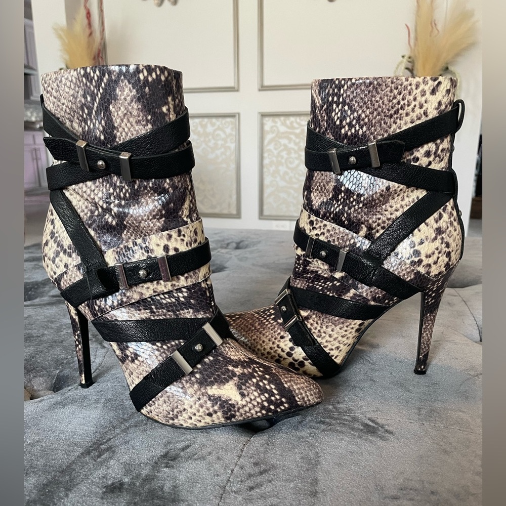 Guess snake print heel boots.